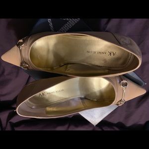 Natural colored kitten heel pointed toe shoe.